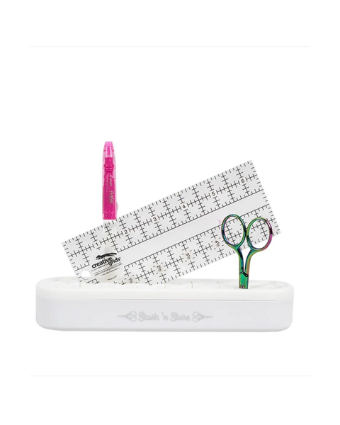 Set of sewing tools including a ruler, scissors, and a pink object on a white background