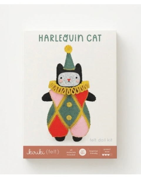 A felt doll kit box for a 'Harlequin Cat' by Kiriki{felt}, featuring a colourful knitted cat illustration in a green, yellow, pink, and red argyle pattern on a white box.