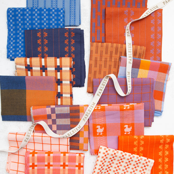 Collection of colorful fabric swatches with a visible brand name on a white background