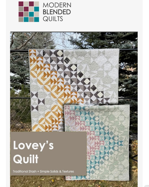 Two quilts with geometric patterns displayed outdoors, featuring the brand 'Modern Blended Quilts'.