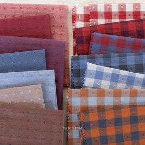 assorted colours of plain cotton fabric and gingham with tiny woven hearts