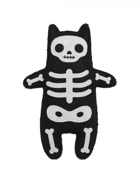 A black plush cat-shaped toy or cushion with a white skeleton print, shown against a plain white background.