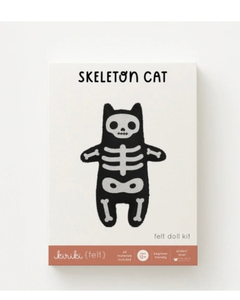 The product packaging for the 'Skeleton Cat' felt doll kit by Kiriki (felt). The box is off-white with a black illustration of a cat skeleton and a terracotta-colored bottom banner containing the brand name.