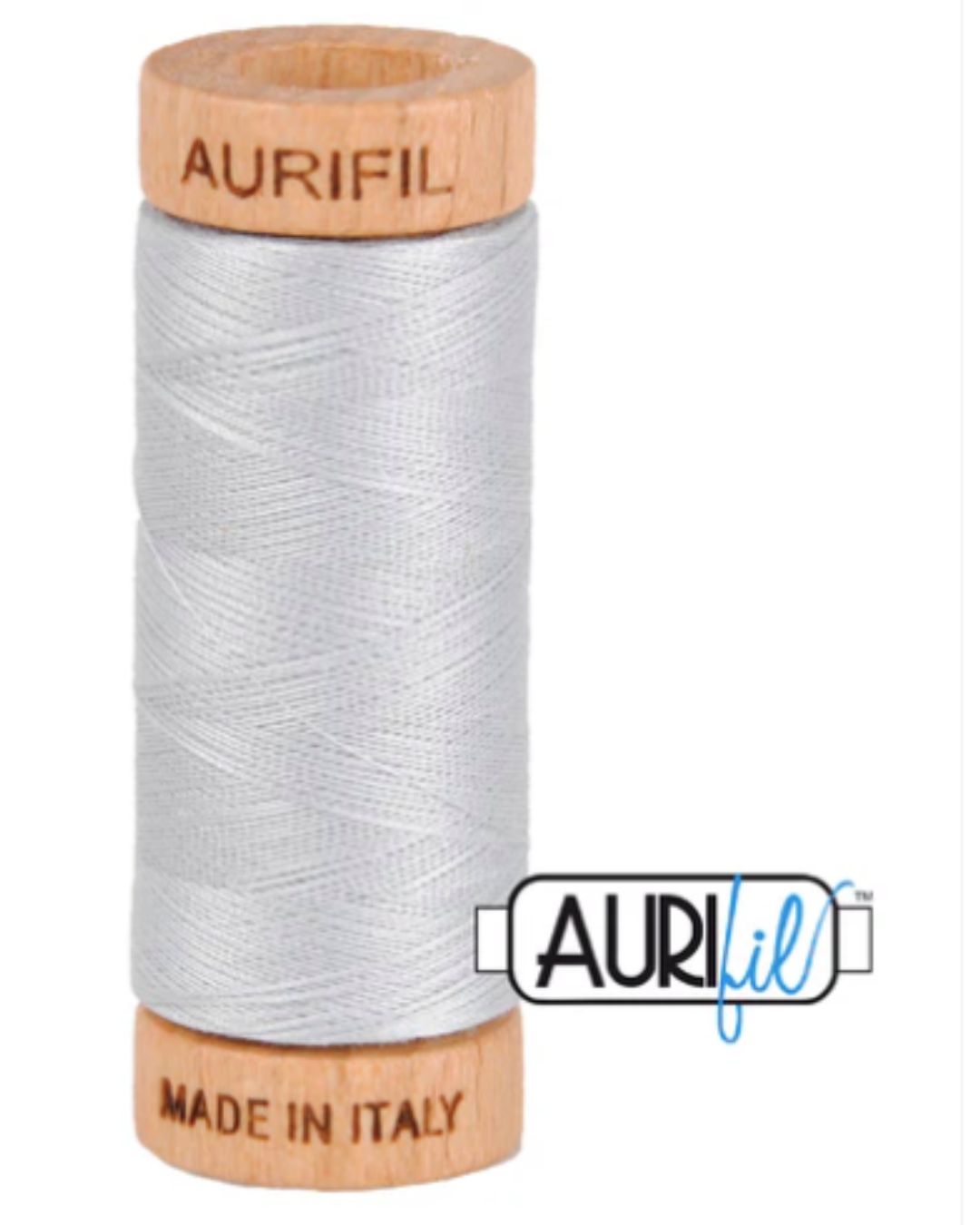 Spool of Aurifil thread with wooden cap on a white background