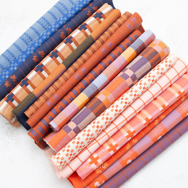 Set of fabric rolls with colorful patterns on a white background