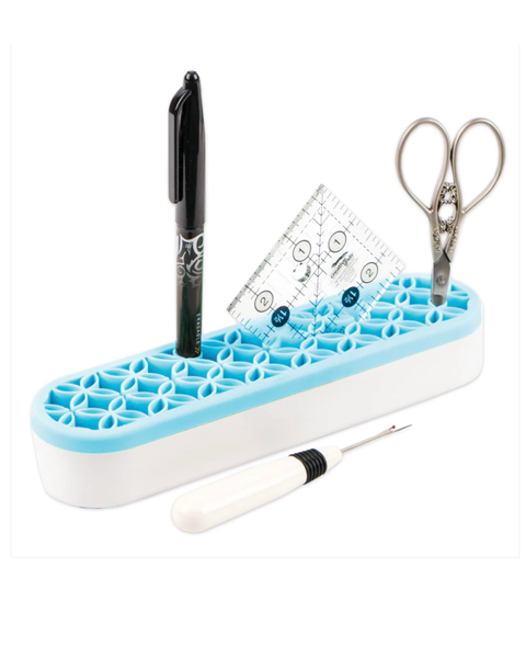 Desk organizer with pen holder, scissors, and measuring tools on a white background