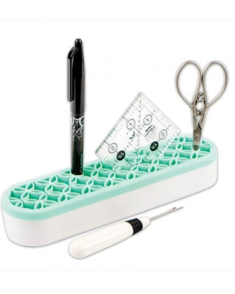 Desk organizer with pen, scissors, ruler, and thermometer on a white background