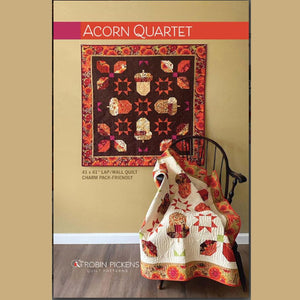 Quilt pattern book cover featuring a quilt with acorn design and another quilt draped over a chair.