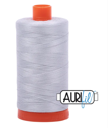 Spool of Aurifil thread with orange top and bottom on a white background