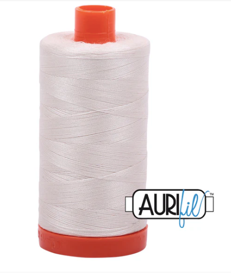 Spool of white thread with red ends and Aurifil logo on a white background