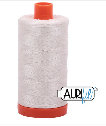 Spool of white thread with red ends and Aurifil logo on a white background