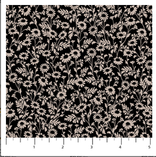 Floral pattern on black fabric with a ruler at the bottom