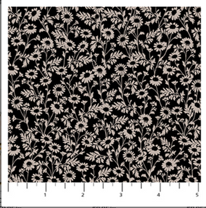Floral pattern on black fabric with a ruler at the bottom