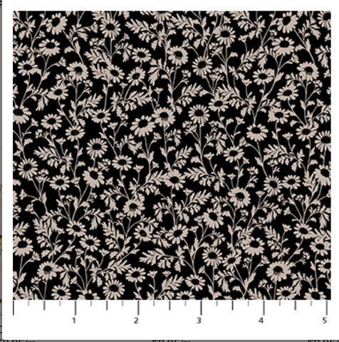 Floral pattern on black fabric with a ruler at the bottom