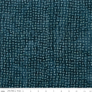 Textured blue fabric pattern with a ruler at the bottom for scale.