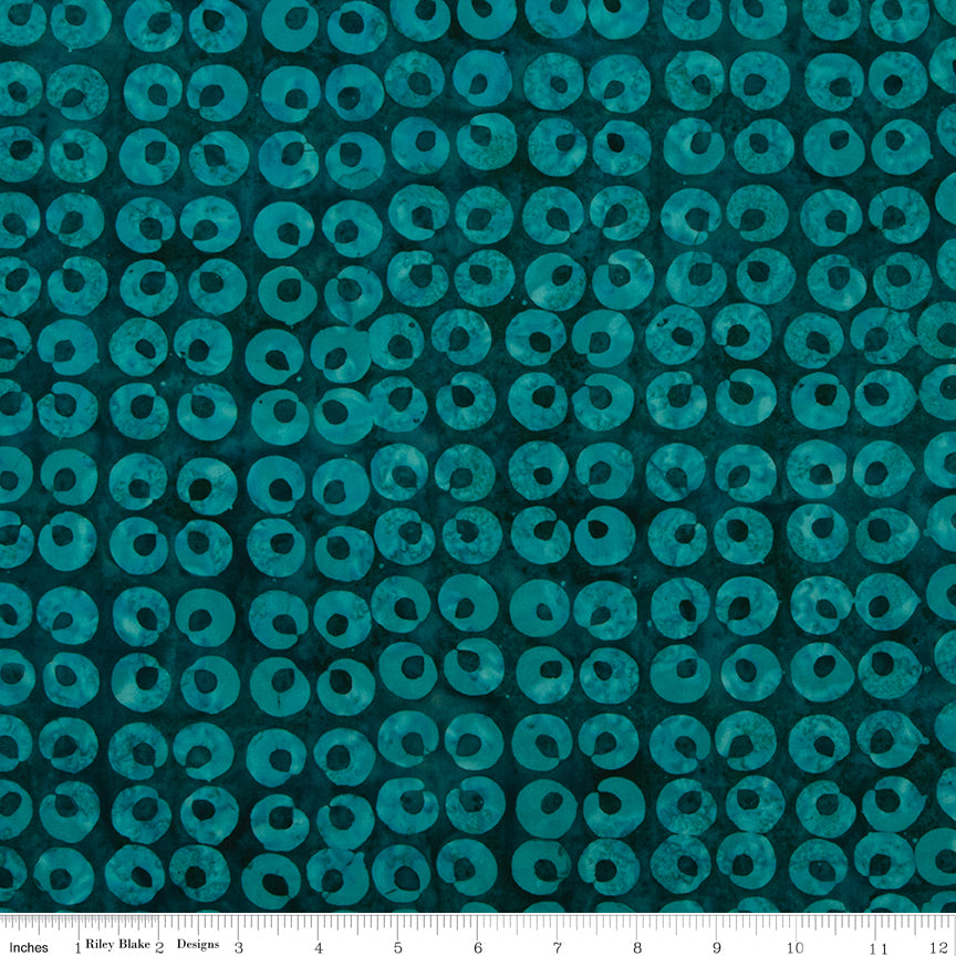 Teal fabric with circular pattern on a blue background