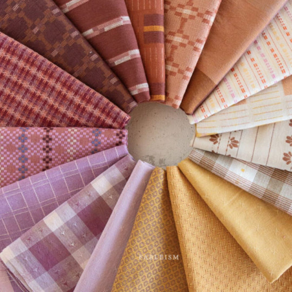 fat quarters in shades of lilac, yellow, neutral and terracotta 