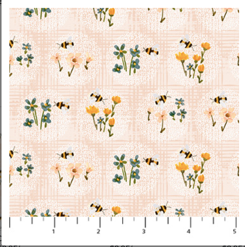 Pattern of bees and flowers on a fabric swatch with a ruler at the bottom.