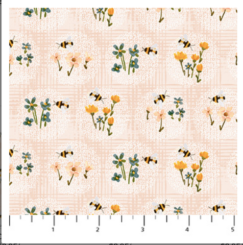 Pattern of bees and flowers on a fabric swatch with a ruler at the bottom.