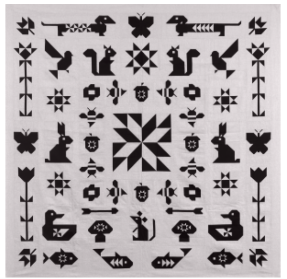 Patterned fabric with black animal and geometric designs on a white background
