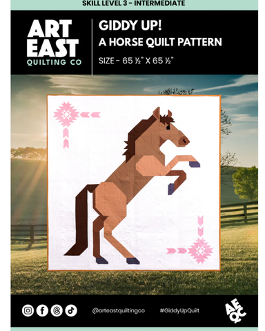 Pattern cover from Art East quilt company of a brown horse rearing up on its hind legs on a white background with pink quilt blocks in opposite corners