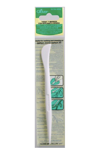 White marking tool with green and white packaging on a white background