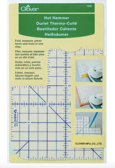 Wide ruler in white with blue lines in a yellow package with green at the top