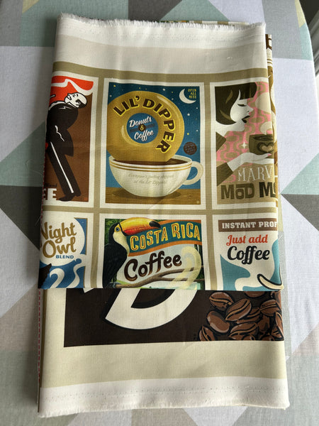 Fabric with coffee-themed design on a gray surface