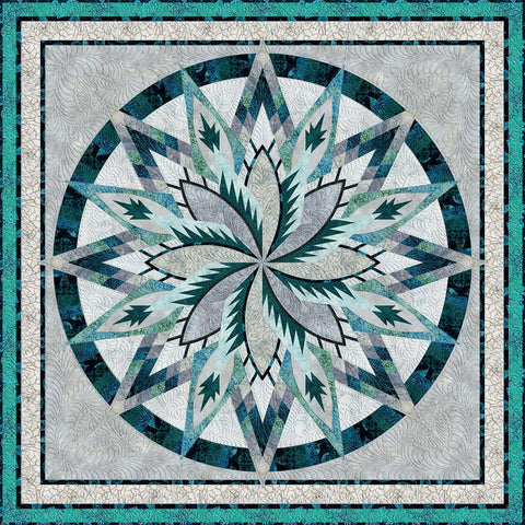 Large star shaped quilt in assorted shades of blue, green and gray