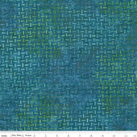 Textured blue and green fabric pattern with a ruler at the bottom