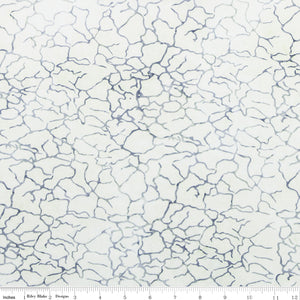 White fabric with blue cracked pattern, measurement scale at the bottom