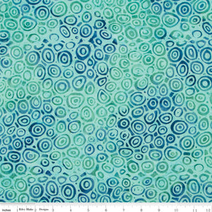 Patterned fabric with blue and green circles on a white background