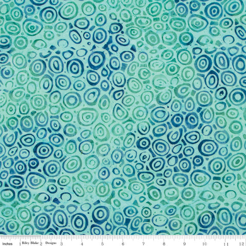 Patterned fabric with blue and green circles on a white background