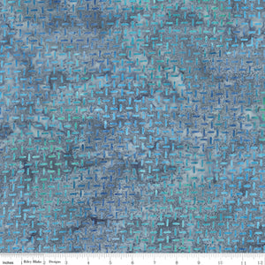 Blue textured fabric pattern with a ruler at the bottom