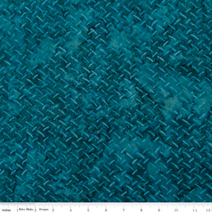 Teal fabric with a textured pattern, featuring a scale at the bottom for measurement.