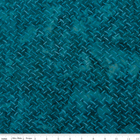 Teal fabric with a textured pattern, featuring a scale at the bottom for measurement.
