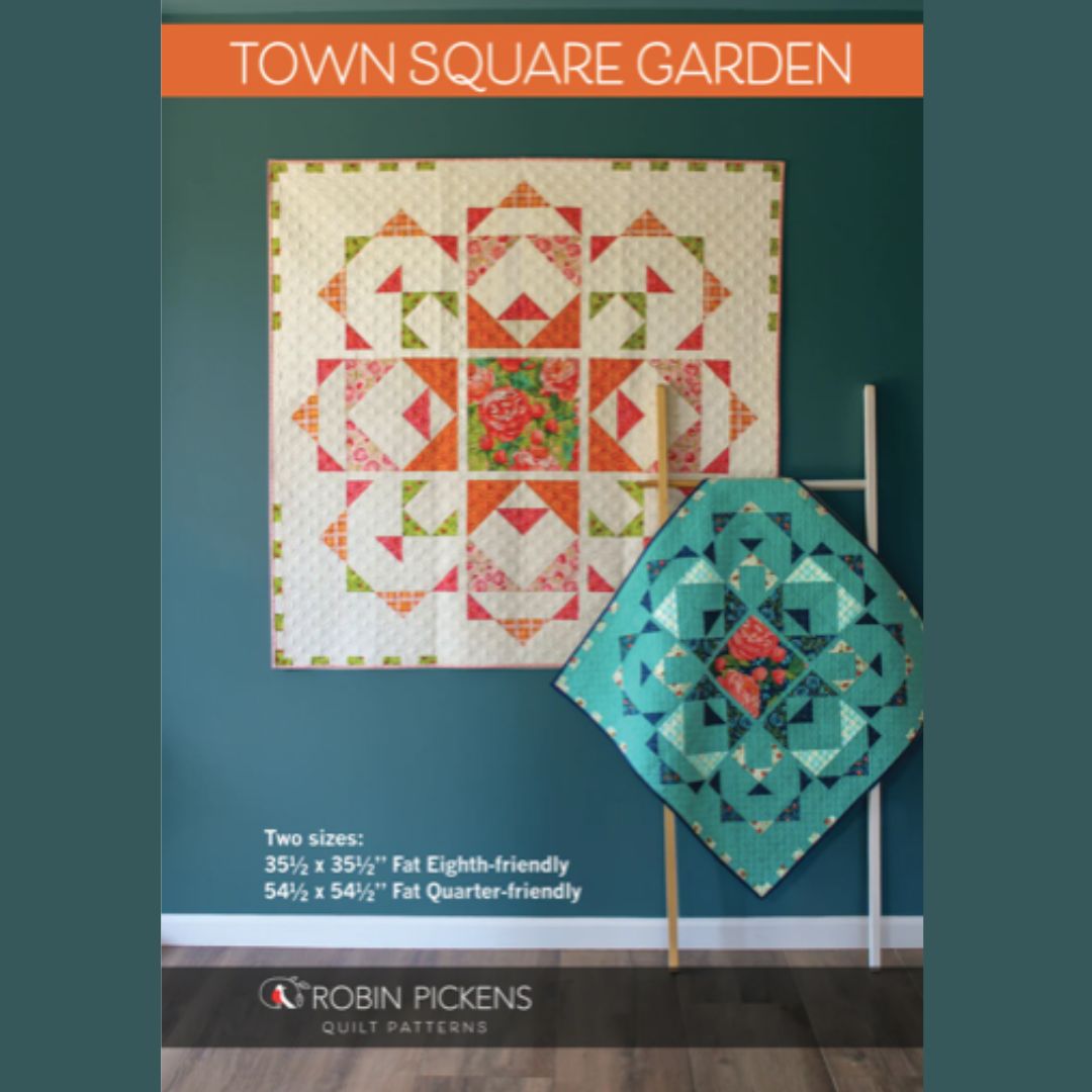 Quilt pattern cover with two quilted pieces on a teal background