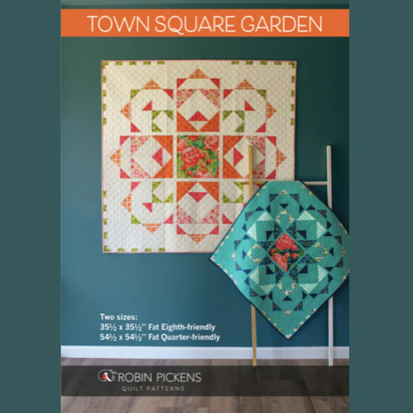 Quilt pattern cover with two quilted pieces on a teal background