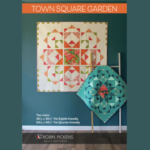 Quilt pattern cover with two quilted pieces on a teal background