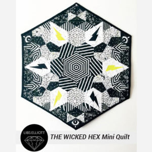 Hexagonal quilt with geometric pattern on a white background, featuring the brand 'Libs Elliott'.