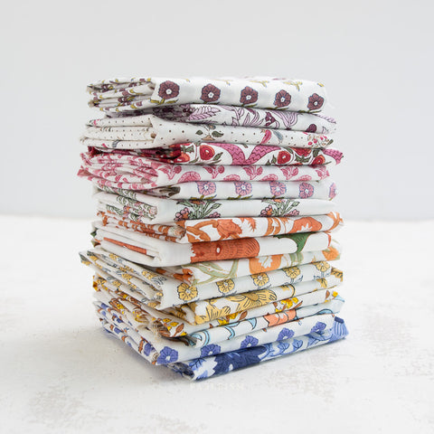 stack of folded printed fabrics